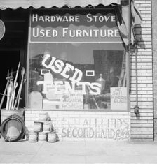 Storefront of San Joaquin Valley town, Fresno, on U.S. 99, California, 1939. Creator: Dorothea Lange