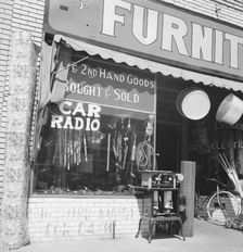 Storefront of San Joaquin Valley town, Fresno, on U.S. 99, California, 1939. Creator: Dorothea Lange