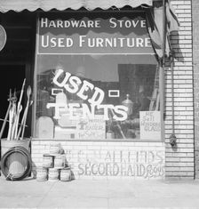 Storefront of San Joaquin Valley town, Fresno, on U.S. 99, California, 1939. Creator: Dorothea Lange