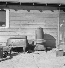 Stoves outside the Browning house being repaired for winter use, Dead Ox Flat, Oregon, 1939. Creator: Dorothea Lange