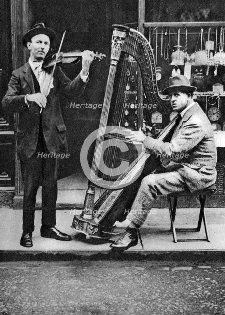 Street musicians, London, 1926-1927. Artist: Unknown