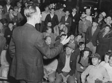 Street meeting at night in Mexican town outside of Shafter, California, 1938. Creator: Dorothea Lange
