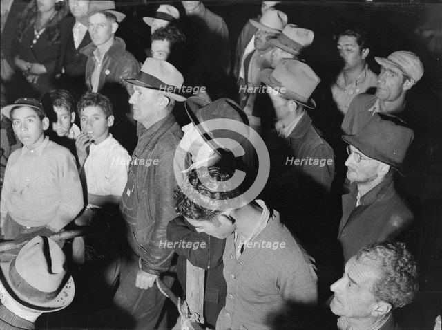 Street meeting at night in Mexican town outside of Shafter, California, 1938. Creator: Dorothea Lange.