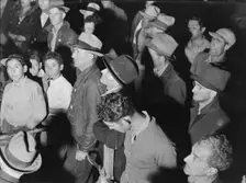 Street meeting at night in Mexican town outside of Shafter, California, 1938. Creator: Dorothea Lange