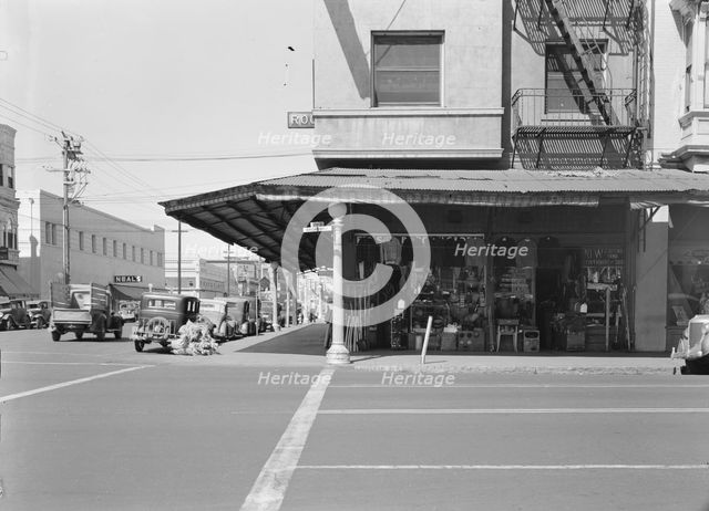 Street corner of San Joaquin Valley town on U.S. 99 showing secondhand store, Fresno, CA, 1939. Creator: Dorothea Lange.