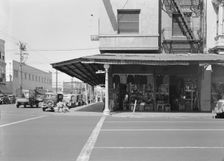 Street corner of San Joaquin Valley town on U.S. 99 showing secondhand store, Fresno, CA, 1939. Creator: Dorothea Lange