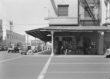 Street corner of San Joaquin Valley town on U.S. 99 showing secondhand store, Fresno, CA, 1939. Creator: Dorothea Lange