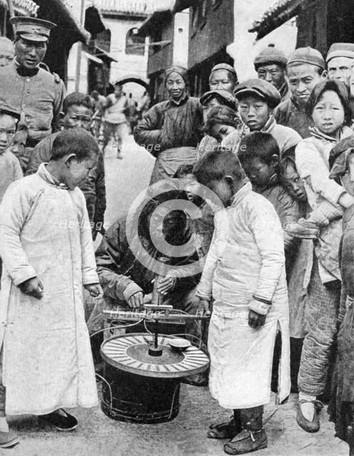 Street gambling, China, 1922. Artist: BT Prideaux