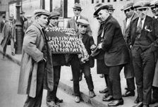Street hawker selling football favours in King's Cross, London, 1911 (1926-1927)