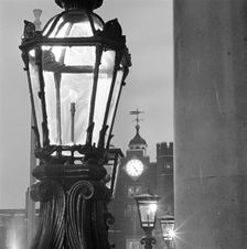 Street lamps at dusk, with the gatehouse of St James's Palace, City of Westminster, London, 1982. Creator: John Gay