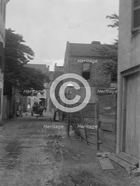 Street scene, New Orleans or Charleston, South Carolina, between 1920 and 1926. Creator: Arnold Genthe.