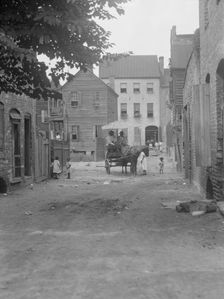 Street scene - looking north on Bedons Alley to Elliott Street; with horse and wagon..., c1920-1926. Creator: Arnold Genthe