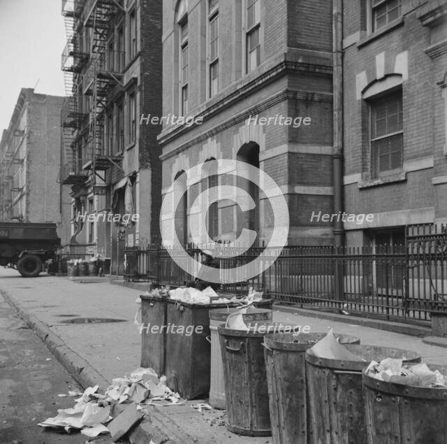 Street scene showing open trash cans along the curb, New York, 1943. Creator: Gordon Parks.
