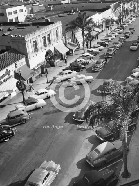 Street scene with cars parked, USA, c1952. Artist: Unknown