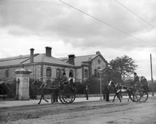 Street scene with horse carriages - possibly Ireland, 1898. Creator: Robert Augustus Henry L'Estrange