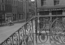 Street seen from behind the wrought iron railing of the Market Hall, Charleston..., c1920-c1926. Creator: Arnold Genthe