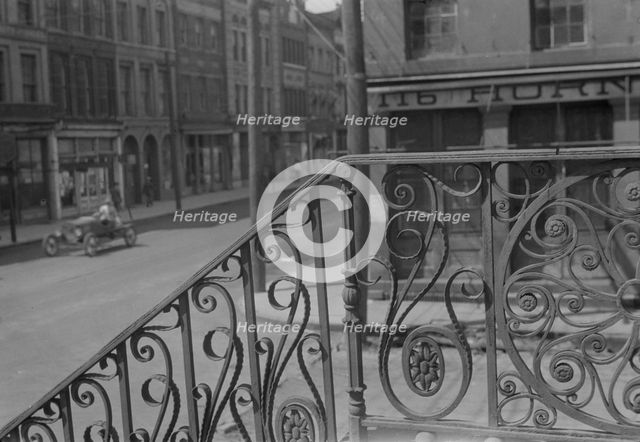 Street seen from behind the wrought iron railing of the Market Hall, Charleston..., c1920-c1926. Creator: Arnold Genthe.