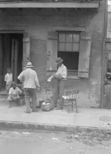 Street vendor, New Orleans, between 1920 and 1926. Creator: Arnold Genthe