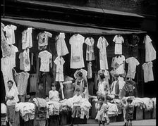 Street View of Street Market Selling Clothes in New York City, 1932. Creator: British Pathe Ltd