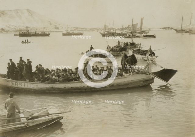 String of pontoons in tow of stream launch, approaching landing stage, Chemulpo, c1904. Creator: Robert Lee Dunn.