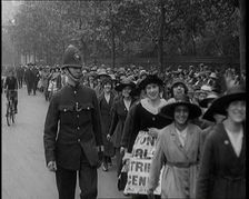 Striking Tea Shop Ladies Marching Down the Road, Flanked by Police, 1920. Creator: British Pathe Ltd