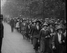 Striking Tea Shop Ladies Marching Down the Road, Flanked by Police, 1920. Creator: British Pathe Ltd