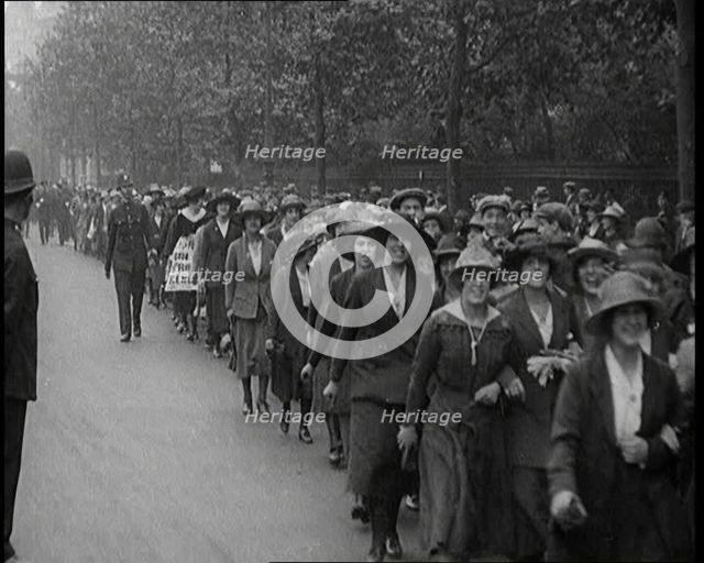 Striking Tea Shop Ladies Marching Down the Road, Flanked by Police, 1920. Creator: British Pathe Ltd.