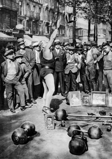 Strongman juggling with weights, Paris, 1931.Artist: Ernest Flammarion