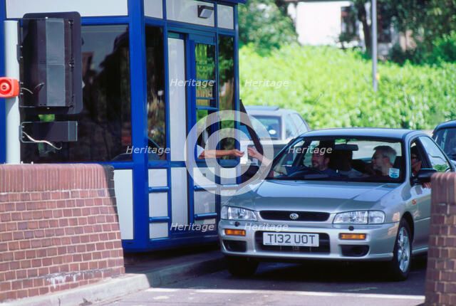 Subaru using toll booth on Itchen bridge, Southampton. Artist: Unknown.