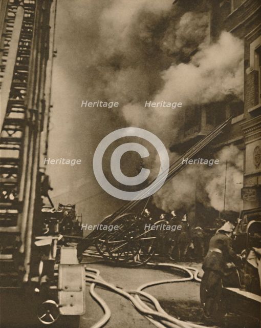 'Subduing a Conflagration in a Narrow City Street', c1935. Creator: Unknown.