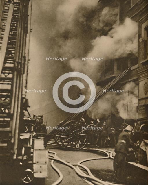 'Subduing a Conflagration in a Narrow City Street', c1935. Creator: Unknown.
