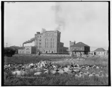Sulphite paper mill and old block house, Sault Ste. Marie, Ont., (1902?). Creator: William H. Jackson