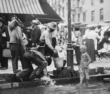 Summer scene, N.Y. - drinking water from street pump, between c1910 and c1915. Creator: Bain News Service