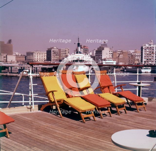 Sun loungers on the deck of a ship at the port of Piraeus, Athens, Greece, c1955. Creator: Arthur Charles Kirby Ware.