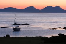 Sunset over Jura seen from Kintyre, Argyll and Bute, Scotland. Creator: Peter Thompson