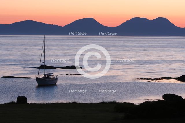 Sunset over Jura seen from Kintyre, Argyll and Bute, Scotland.  Creator: Peter Thompson.