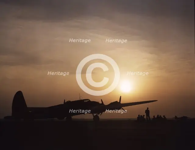 Sunset silhouette of flying fortress, Langley Field, Va., 1942. Creator: Alfred T Palmer.