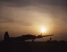 Sunset silhouette of flying fortress, Langley Field, Va., 1942. Creator: Alfred T Palmer