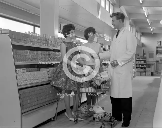 Supermarket shoppers and salesman, Co-op, Barnsley, South Yorkshire, 1961. Creator: Michael Walters.