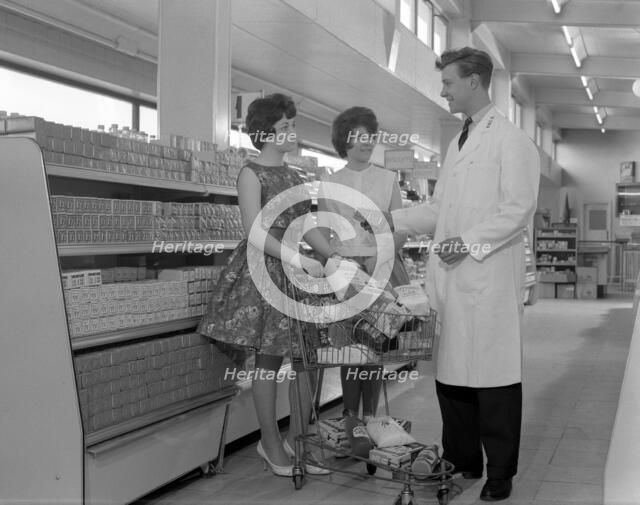 Supermarket shoppers and salesman, Co-op, Barnsley, South Yorkshire, 1961. Artist: Michael Walters