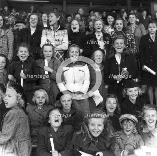 Supporters at a school sports match, Trelleborg, Sweden, 1950. Creator: Unknown.