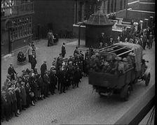 Supply Trucks With Armed Guards Driving Alongside a Crowd of Civilians, 1926. Creator: British Pathe Ltd