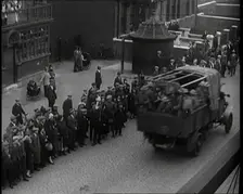 Supply Trucks With Armed Guards Driving Alongside a Crowd of Civilians, 1926. Creator: British Pathe Ltd