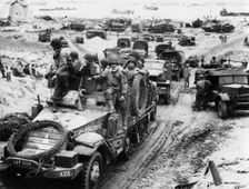 Supplies and troops move inland, Normandy beaches, France, 6 June 1944. Creator: Unknown
