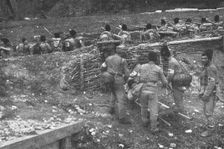 Sur le front Roumain; brancardiers emportant un blesse 1916. Creator: Unknown