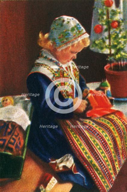 Swedish girl playing with dolls, c1928. Creator: Unknown.
