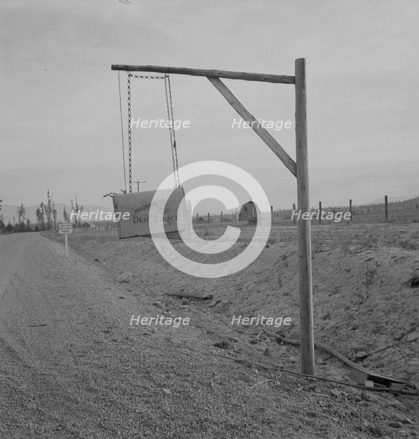 Swinging mail boxes in country where snow is deep in winter, Boundary County, Idaho, 1939. Creator: Dorothea Lange.