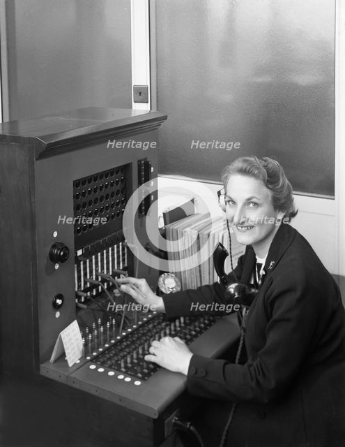 Switch board operator, Spillers Animal Foods, Gainsborough, Lincolnshire, 1960. Creator: Michael Walters.
