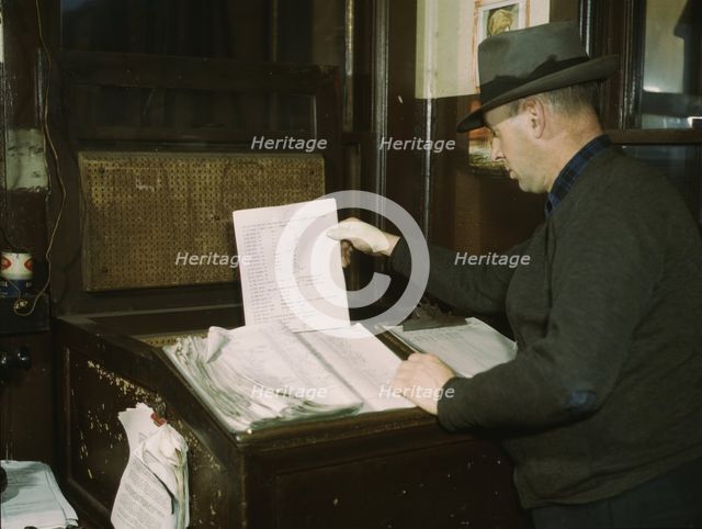 Switch lists coming in by teletype to the hump office at a C& NW RR yard, Chicago, Ill., 1942. Creator: Jack Delano.