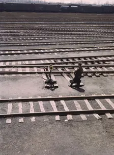 Switchman throwing a switch a C and NW RR's Proviso yard, Chicago, Ill., 1943. Creator: Jack Delano